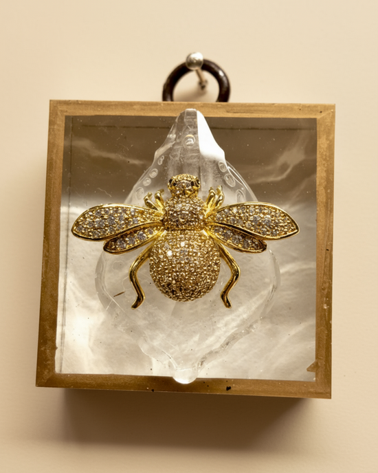 Acrylic frame with a sparkling bee on crystal, slight imperfections, priced at $65.00.