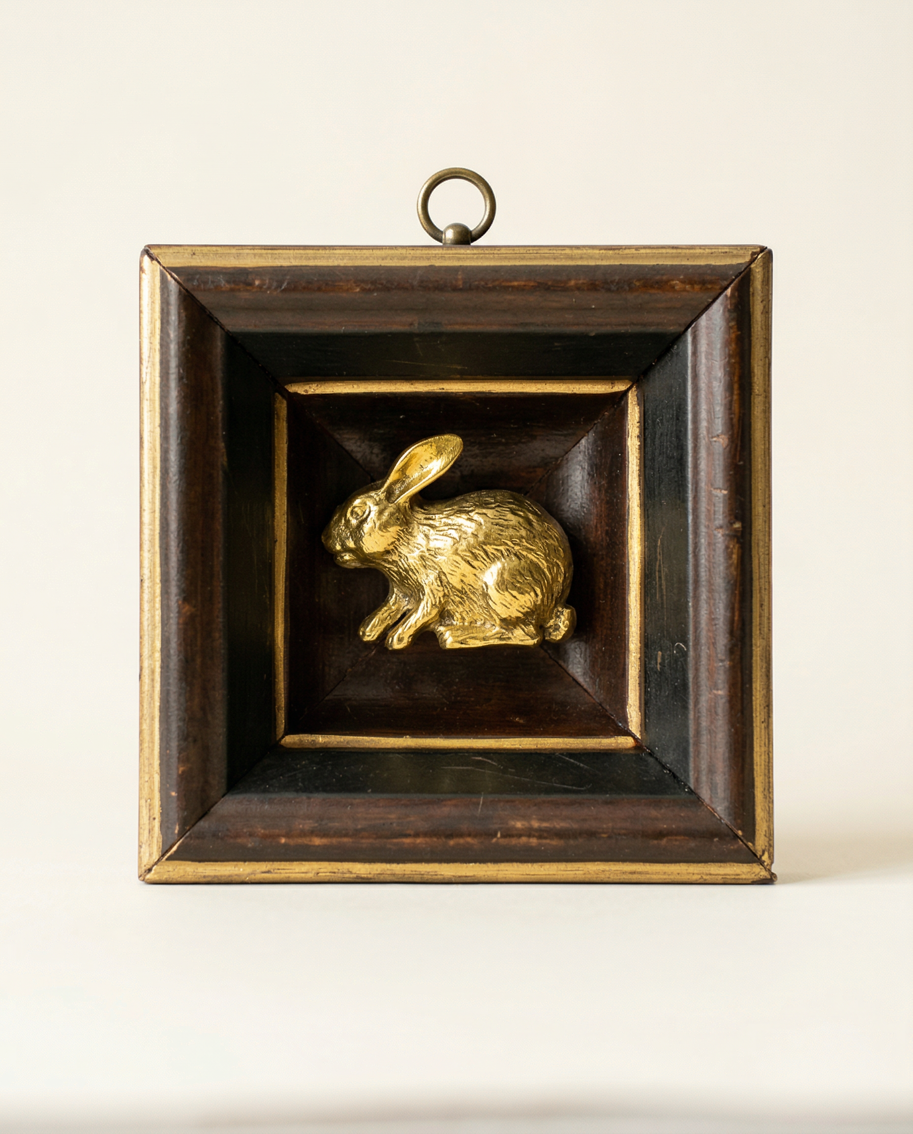 Gold rabbit figurine on a wooden brown frame art
