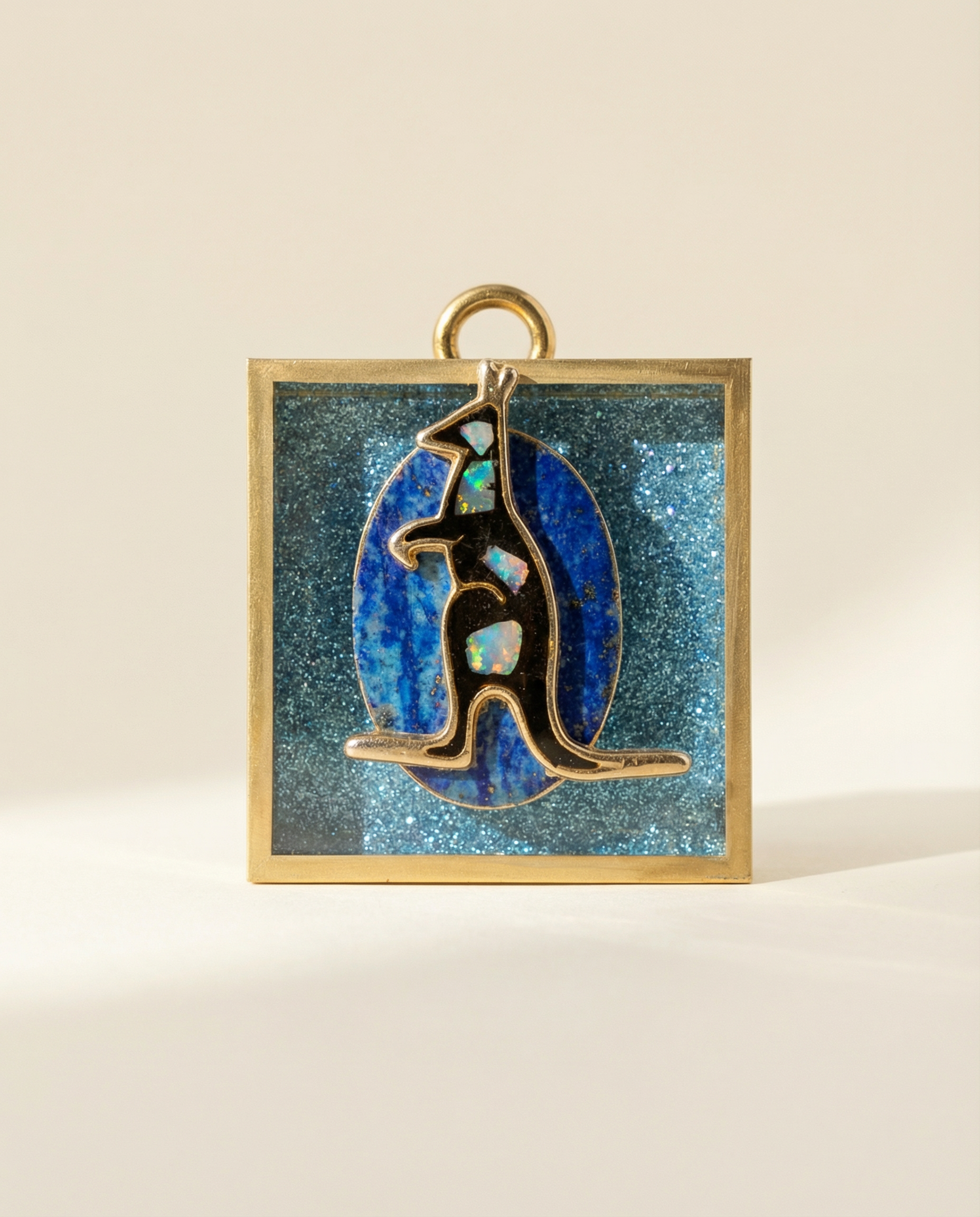 Decorative vintage kangaroo brooch on a blue glittery acrylic frame 