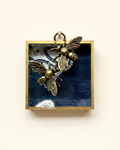 Bronze bee pendants on a blue fabric acrylic frame art 