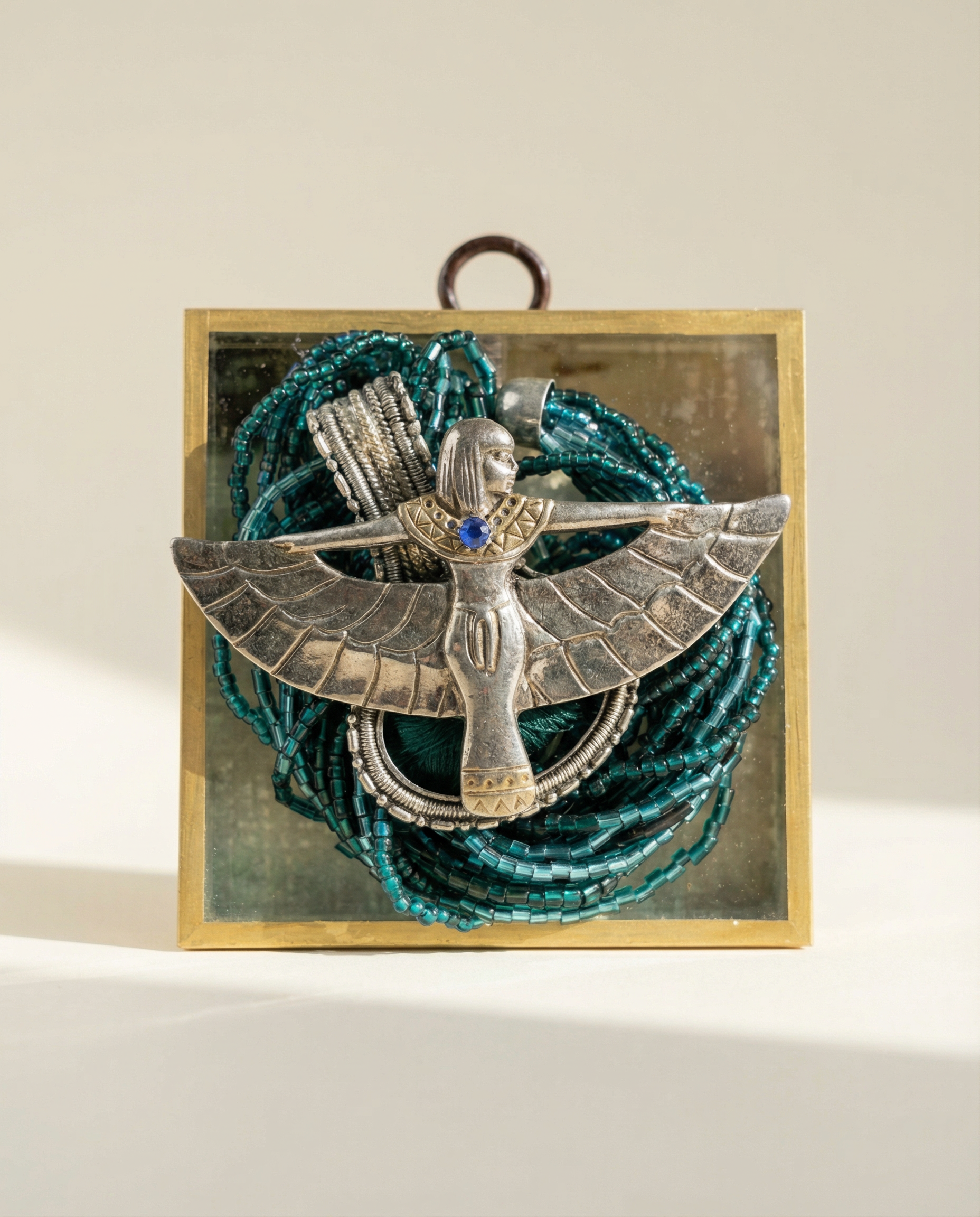 Decorative vintage silver Egyptian brooch  on beaded background acrylic frame 