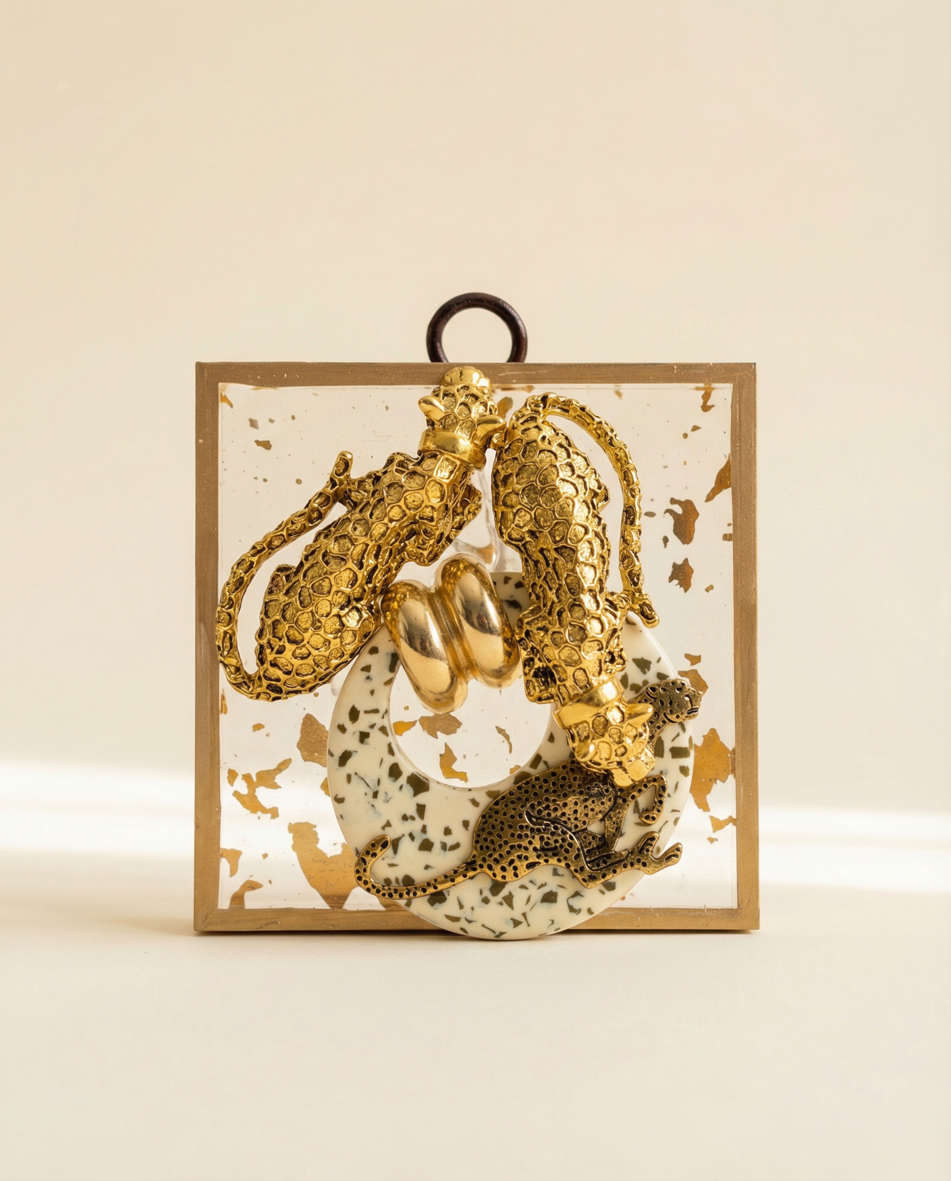 Gold leopard pendants on brooch on acrylic frame art 