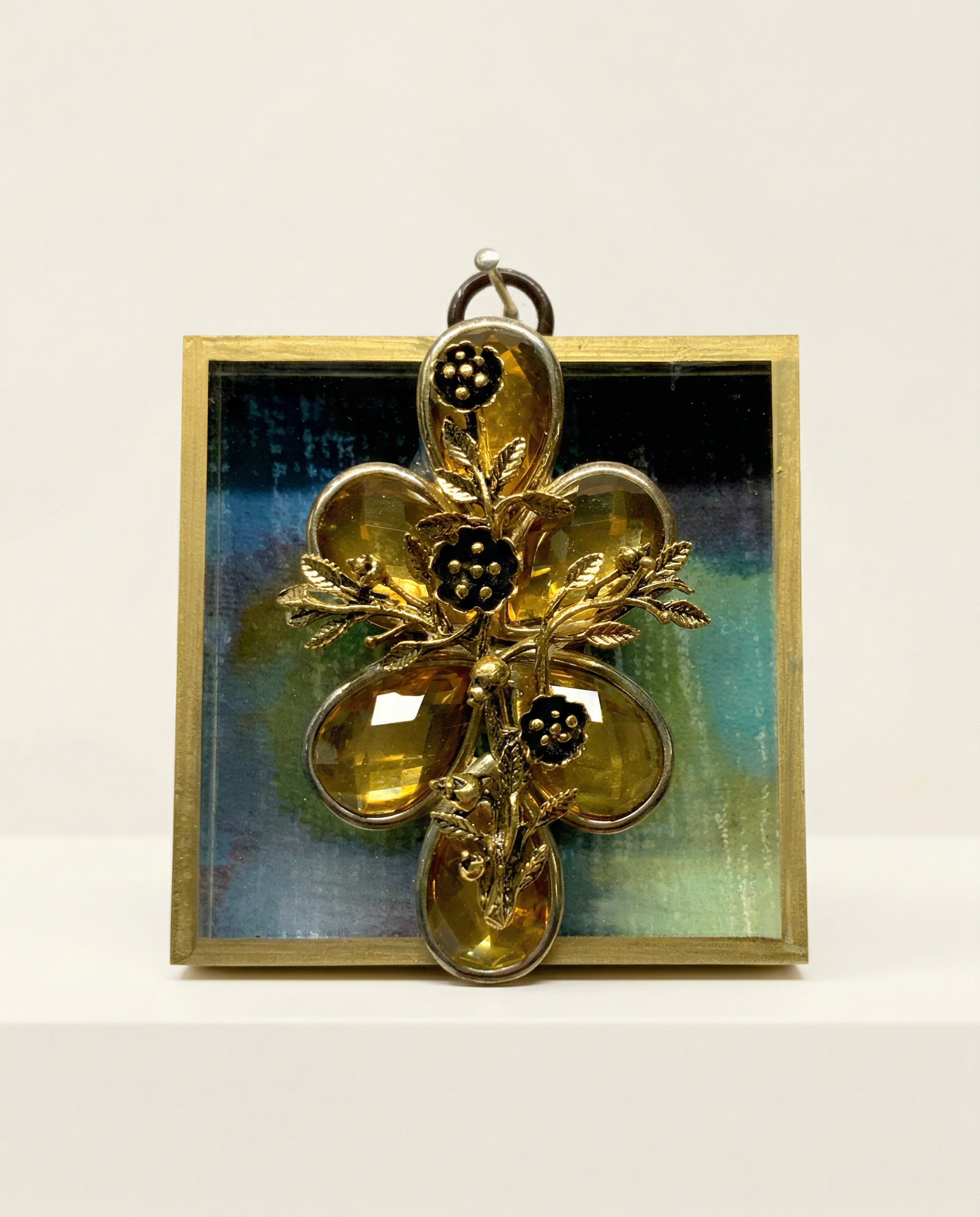 Gold cross pendant with floral design on a marbled acrylic frame art 
