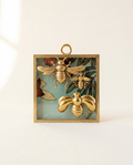 Decorative wall art with gold bees and floral elements on a fabric acrylic frame art 