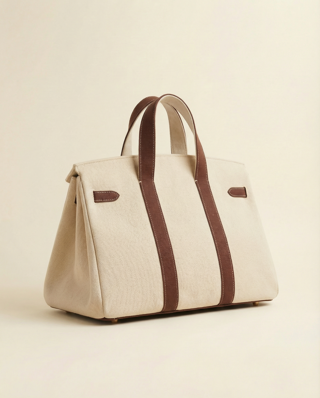 Beige handbag with brown straps on a beige background