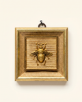Decorative wall art with a gold frame with gold bee and fabric inlay on a wooden frame art