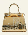 Gold handbag with intricate designs and 'NDG' branding on a white background