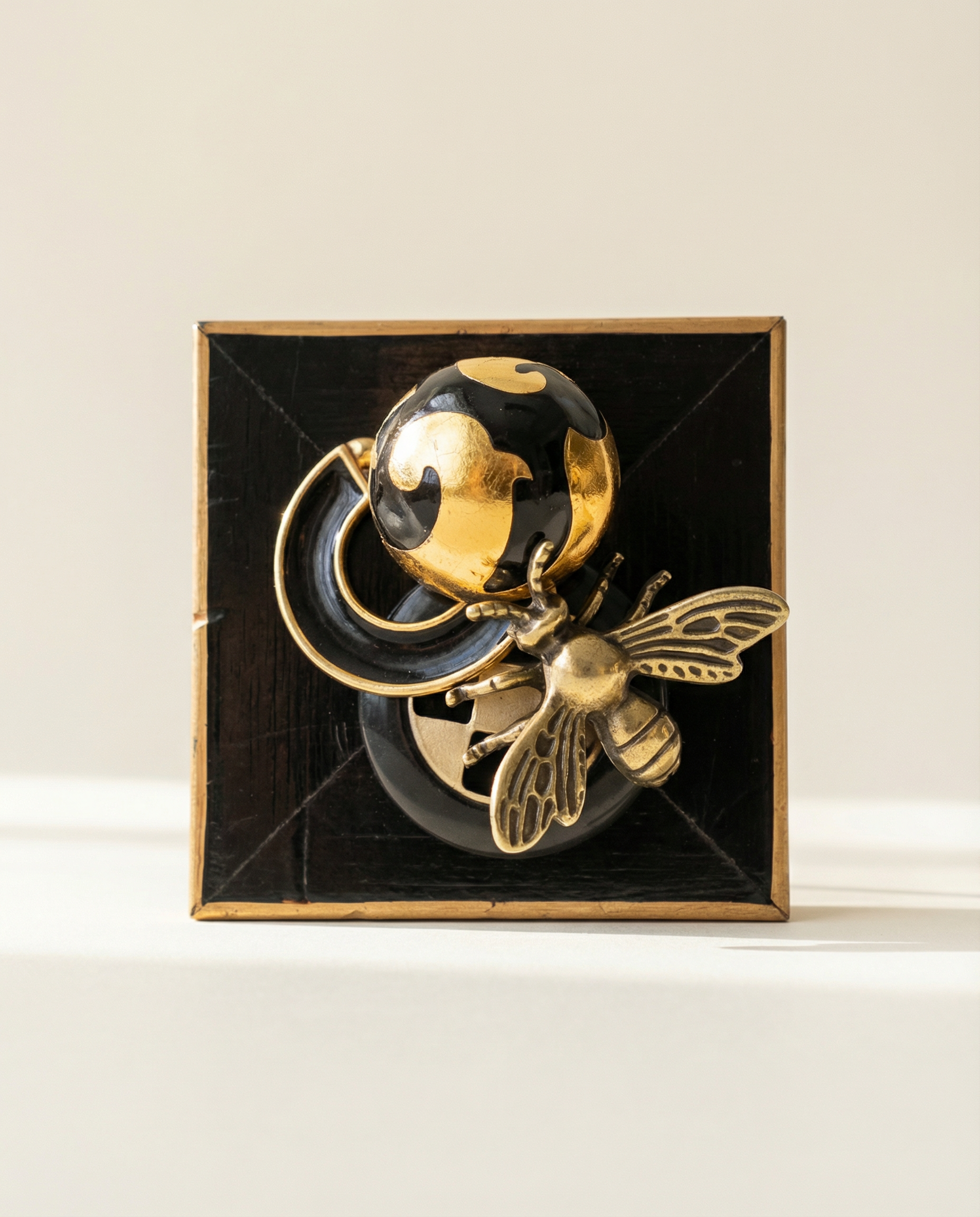 Decorative wall art with gold and black bee design on a wooden frame 