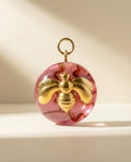 Pink acrylic orb  pendant with gold bee design art 