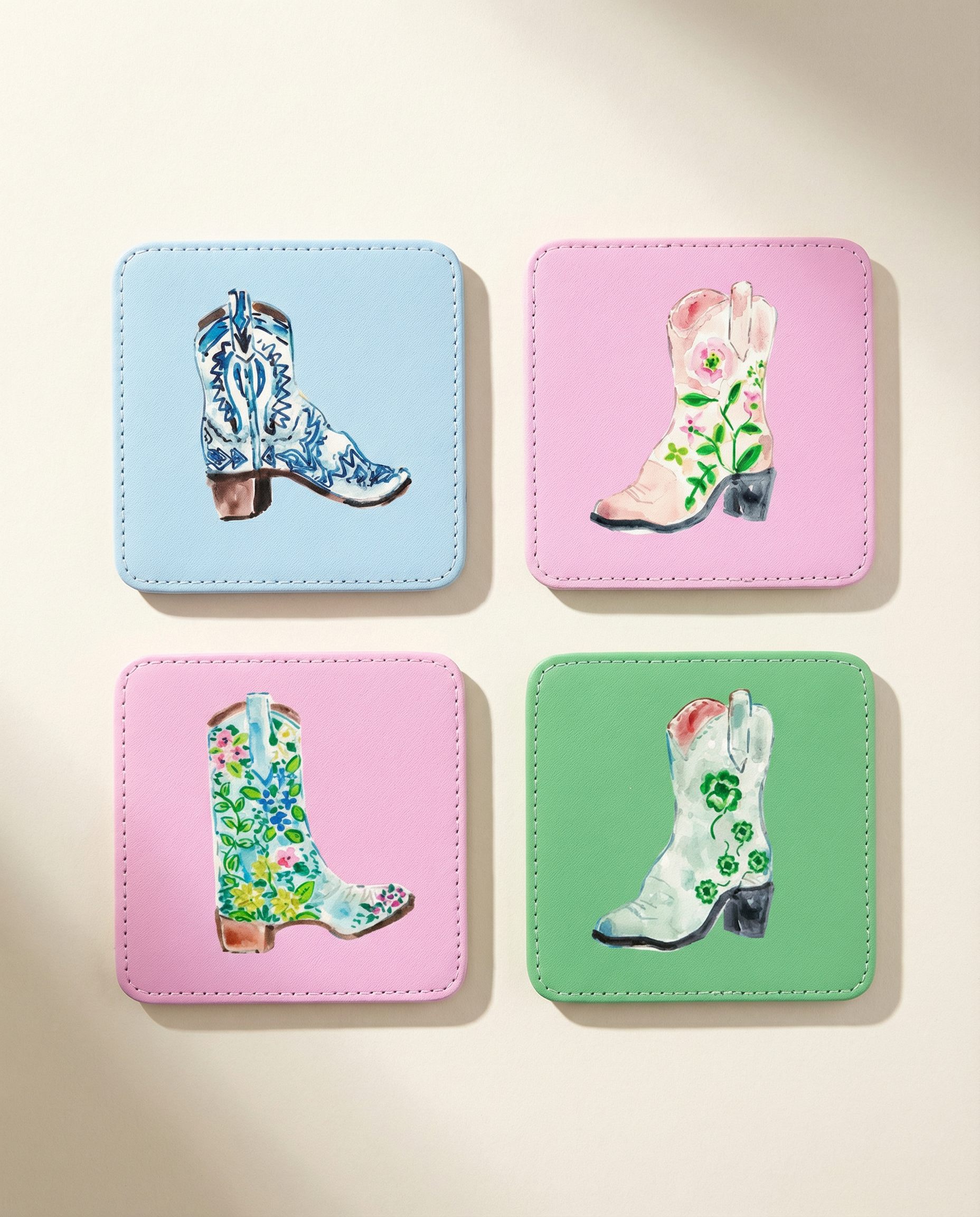 Four colorful coasters with cowboy boot designs on a beige background